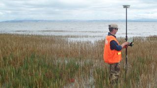 USGS researcher surveying San Francisco Bay marsh.