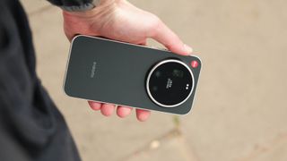 Hand holding the Leica Leitz Phone outdoors