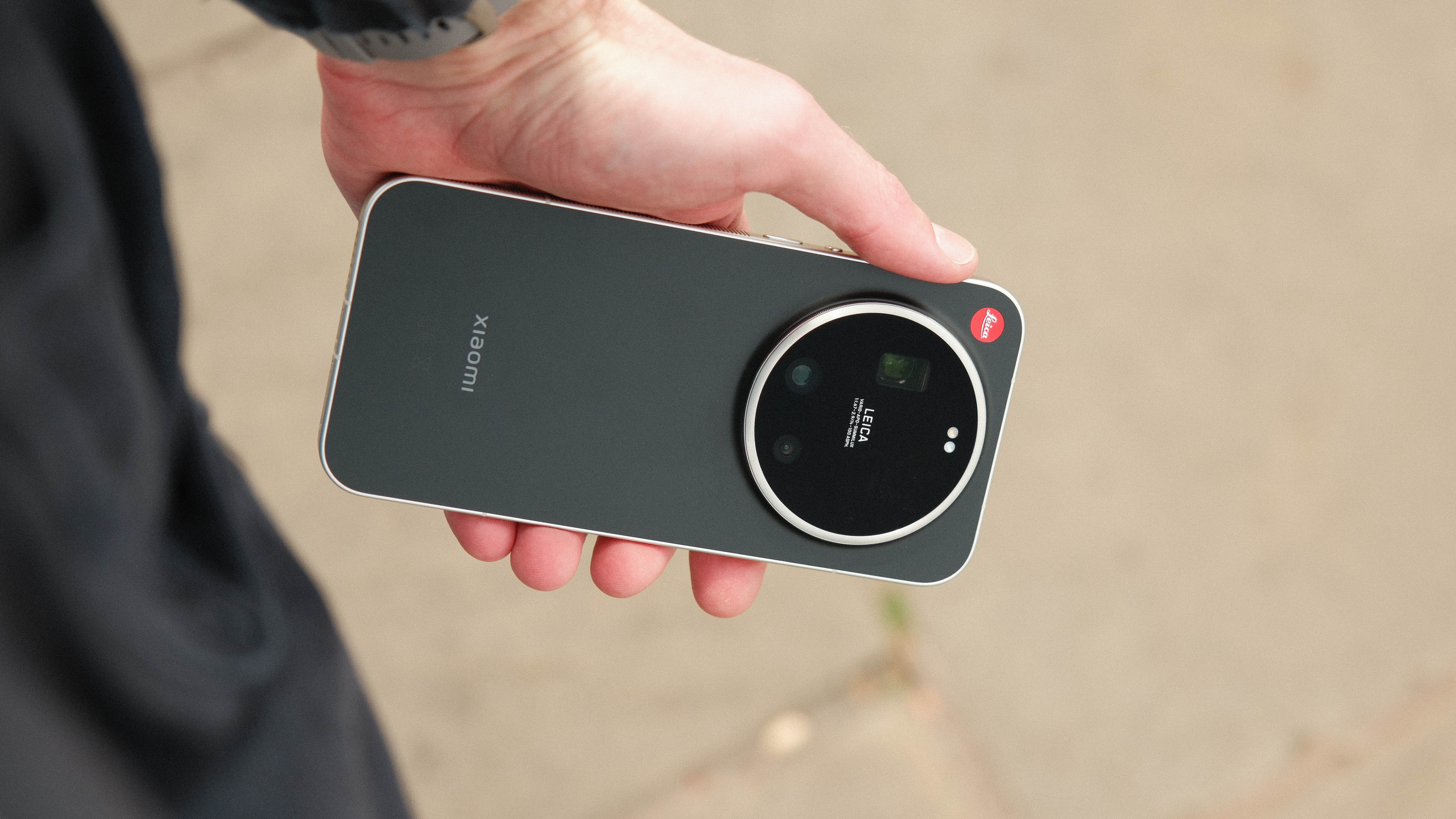 Hand holding the Leica Leitz Phone outdoors