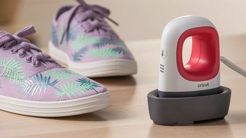 The Cricut EasyPress MIni review uses a photograph of the machine next to some sneakers