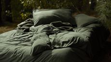 Shleep Essentials Bedding Collection on a bed in the forest.