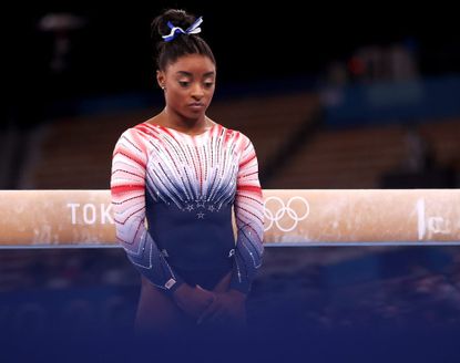 Simone Biles performs the beam at the Tokyo Olympics