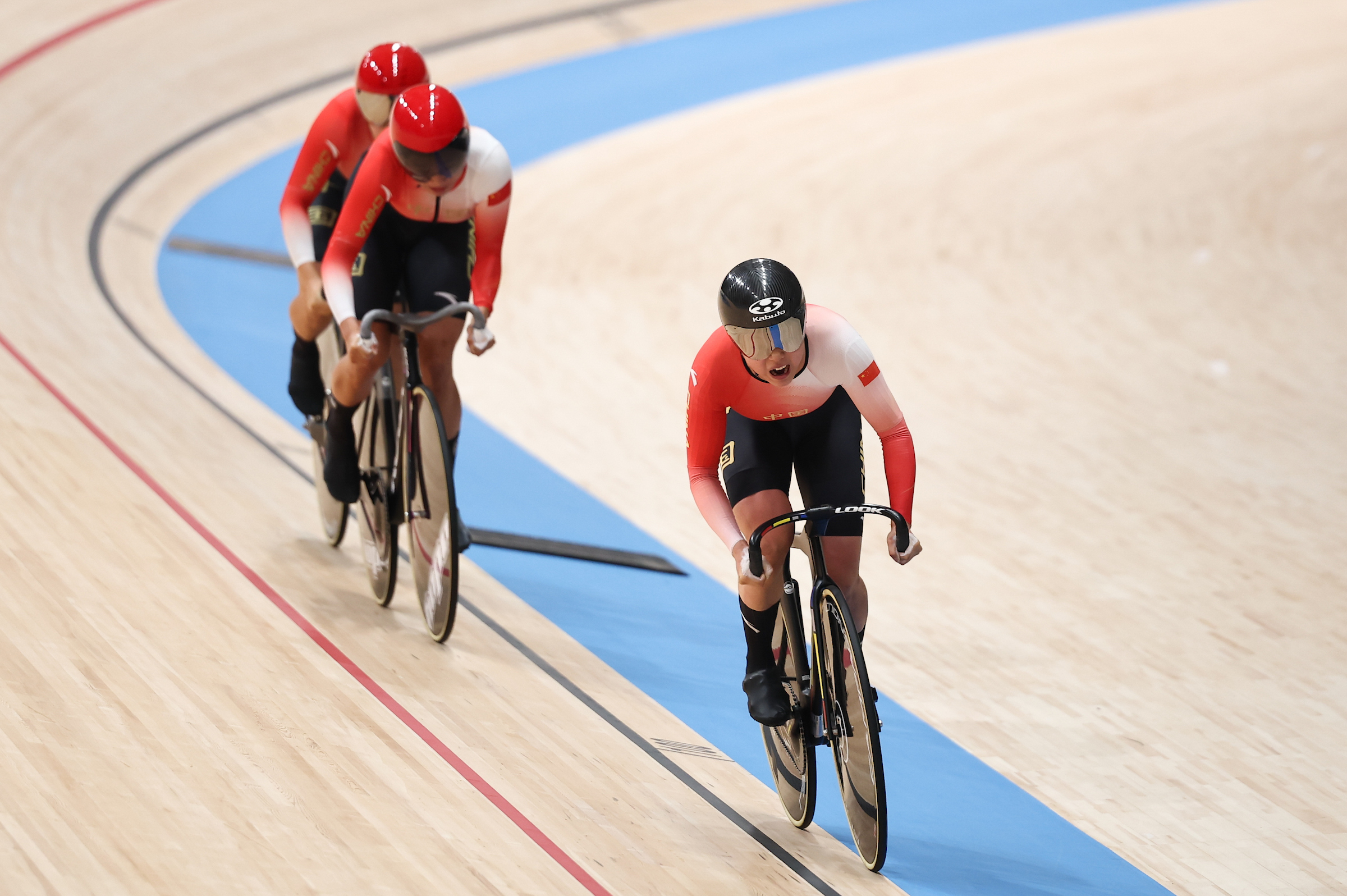 Yulu Jiang, Mengqi Tong, and Liying Yuan (China) racing on the track during the women's team sprint