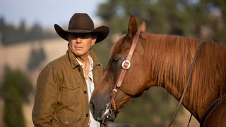 Kevin Costner as John Dutton, next to a horse, in Yellowstone 