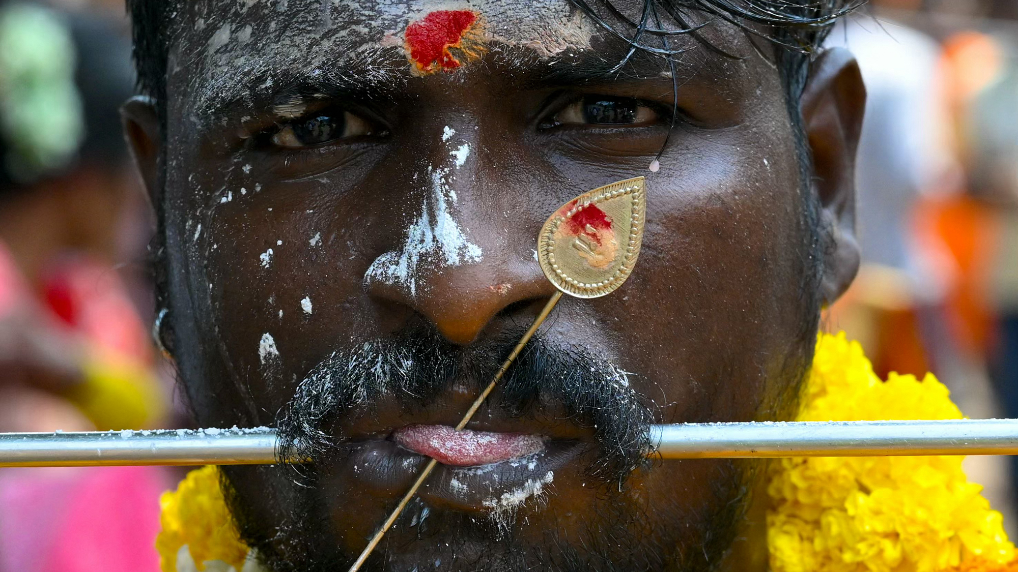 A Tamil Hindu devotee pierces his mouth during the Panguni Uthiram festival in Mumbai, India