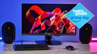 MSI MPG 272URX monitor on desk with speakers and keyboard with Tom's Guide Prime Day badge