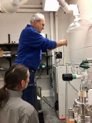 Laboratory technician Jim Zareski (top) loads a programmable furnace as co-author Jim Greenwood looks on, in his laboratory at Wesleyan University. This is where the synthetic chondrules are made.
