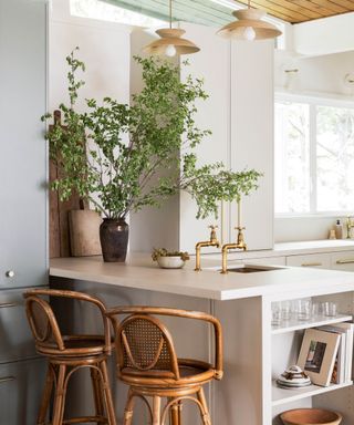 Neutral kitchen with textures and large vase of greenery