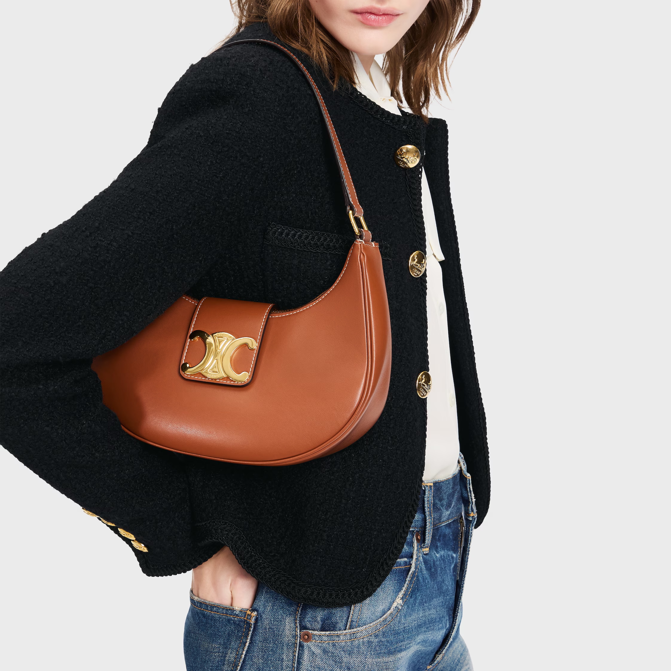 a model wearing celine brown leather triomphe bag