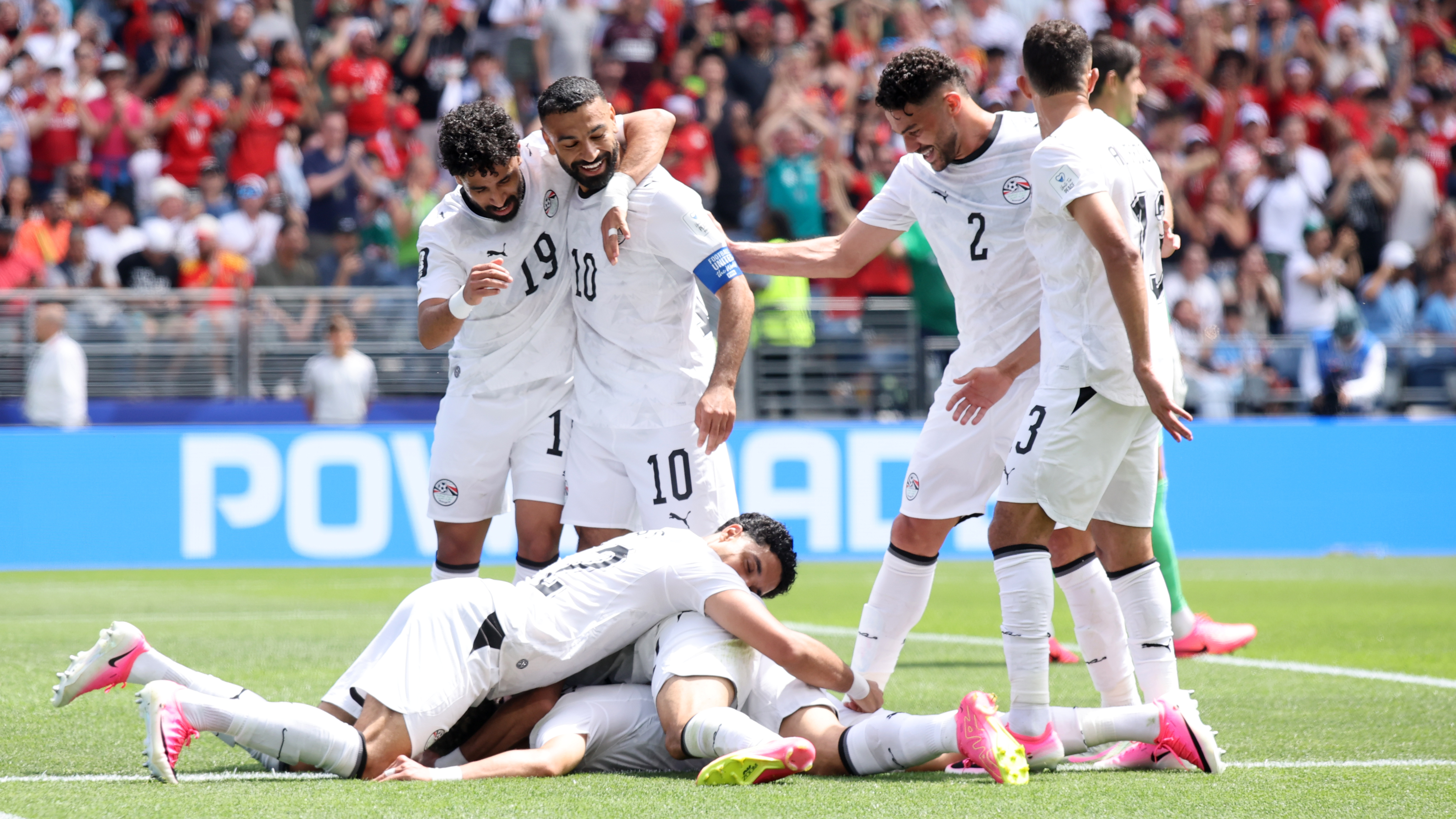 Emam Ashour #8 of Egypt celebrates with teammates after scoring the team's first goal during the FIFA World Cup 2026 Group G match between Belgium and Egypt
