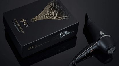 GHD Air hair dryer with box on black background