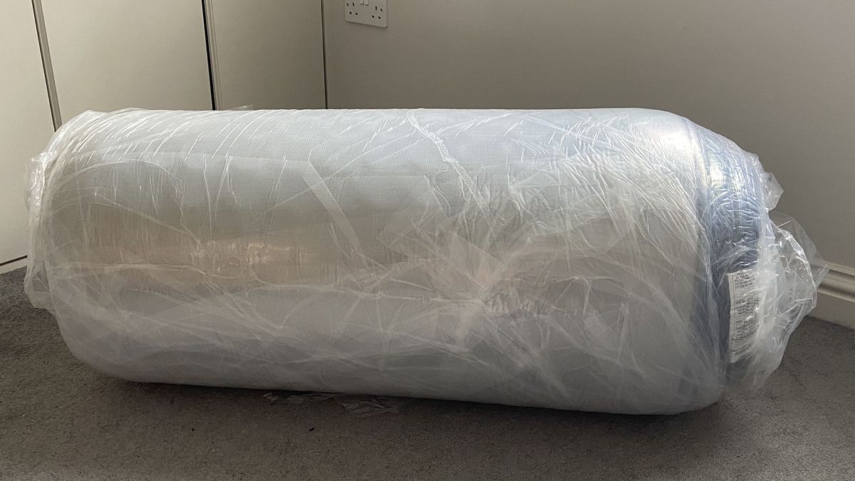 Zoma Boost mattress rolled and wrapped in plastic