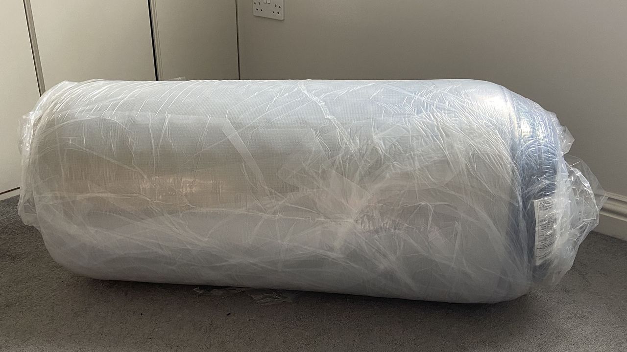 Zoma Boost mattress rolled and wrapped in plastic
