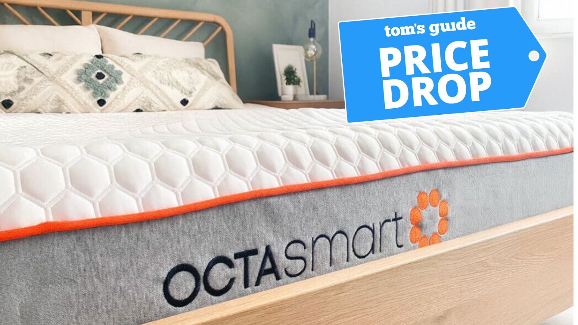 Dormeo's Octasmart Deluxe Memory Foam Mattress on a wooden bed frame. A price drop deals badge is seen in the top right foreground. 