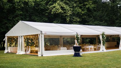 Image depicts a big white wedding tent