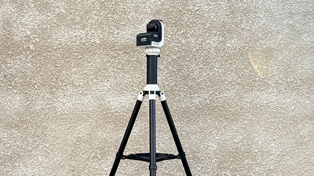 The Sky-Watcher SolarQuest solar telescope mount and tripod against a textured white wall.