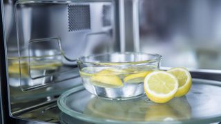 A bowl of water and lemons in a microwave