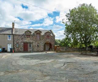 A stone wall facing a street