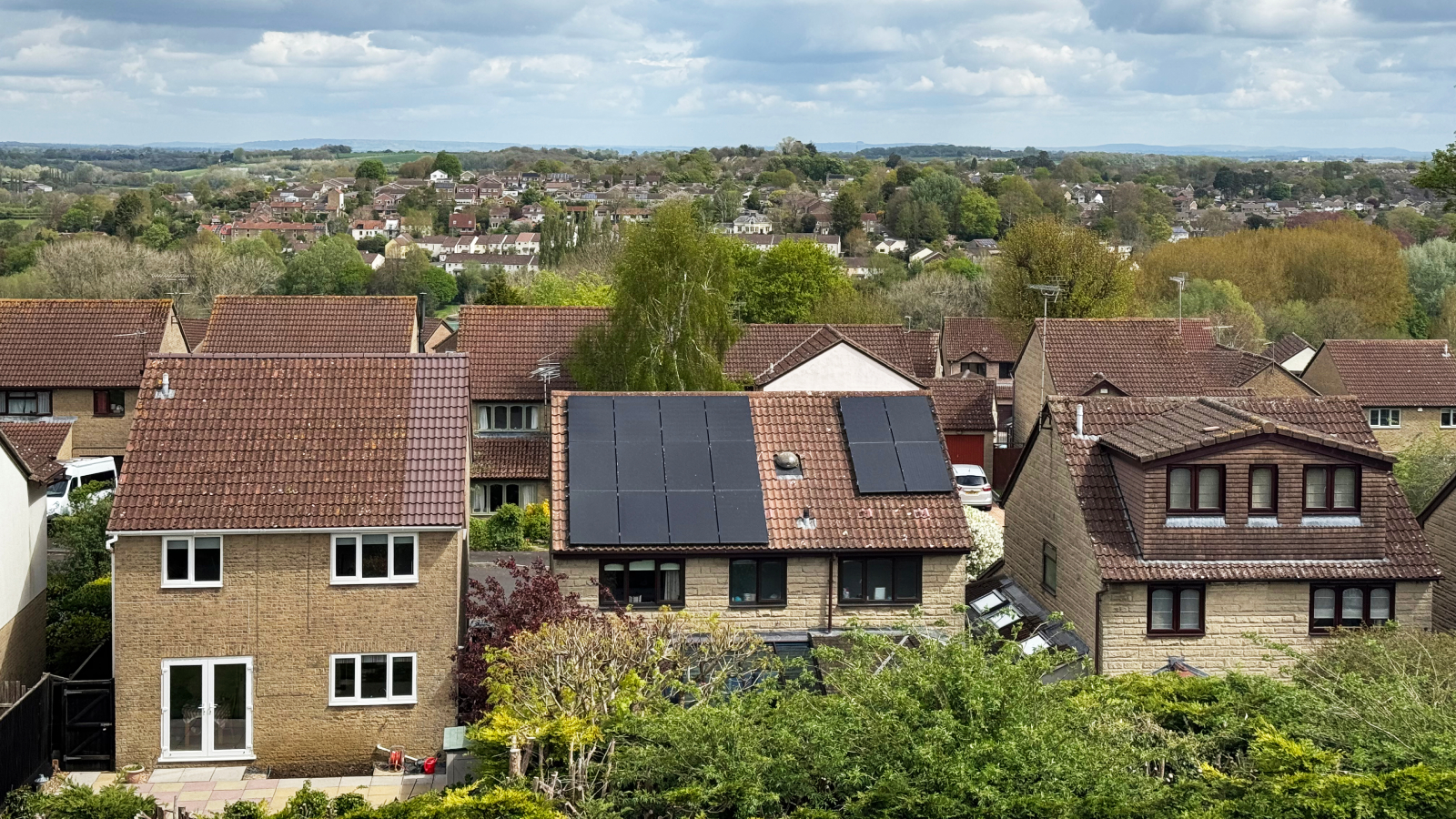 residential houses on street with solar panels on roof of one house