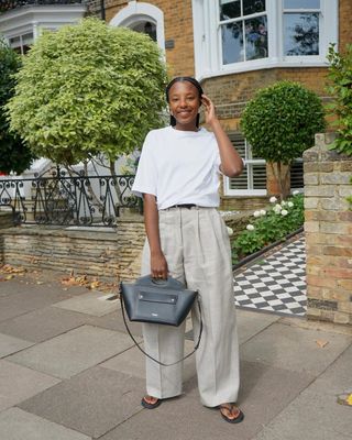 @taffymsipa wearing leather flip flops with linen trousers and a white t-shirt