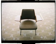 Chair by Robin Day photographed on a patterned carpet