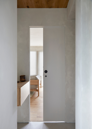 A minimalist corridor leading to the living room