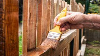 Fence painting using brush and brown best fence paints