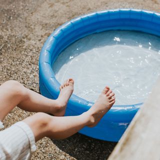 small circular paddling pall with child's feet resting on the edge