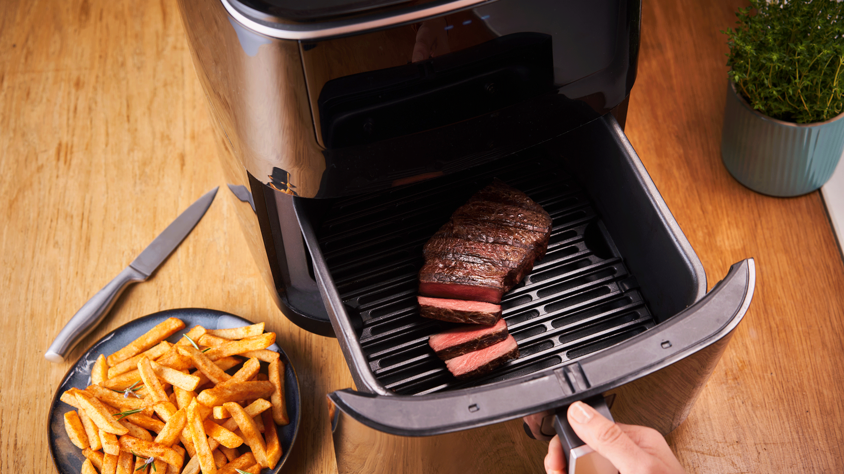 Black air fryer with steak