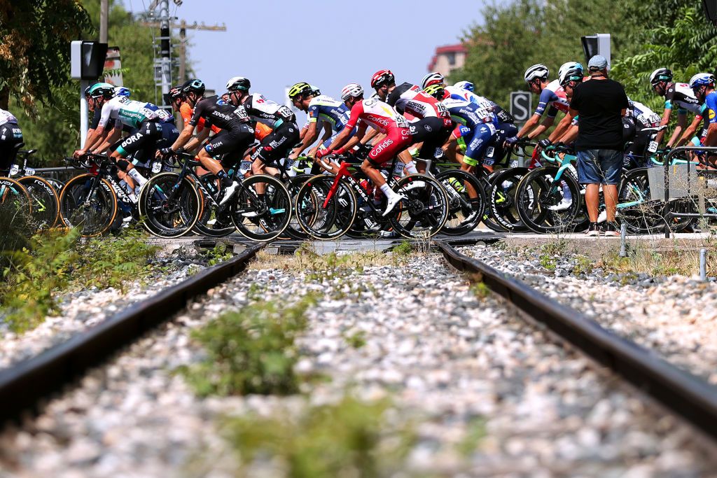 ALBACETE SPAIN AUGUST 18 LR Chris Hamilton of Australia and Team DSM Fernando Barcel Aragn of Spain and Team Cofidis and the Peloton passing through a train tracks prior to the 76th Tour of Spain 2021 Stage 5 a 1844km stage from Tarancn to Albacete lavuelta LaVuelta21 on August 18 2021 in Albacete Spain Photo by Gonzalo Arroyo MorenoGetty Images