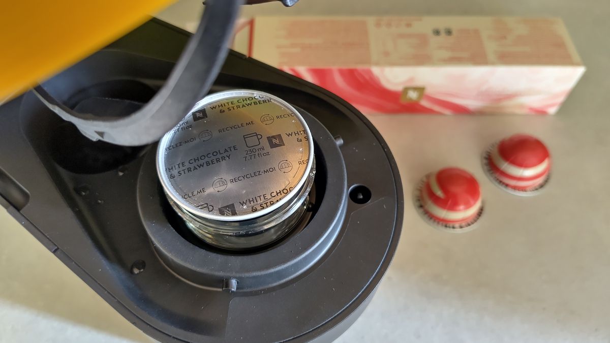 Nespresso white chocolate and strawberry coffee pod inside Nespresso Vertuo Pop machine