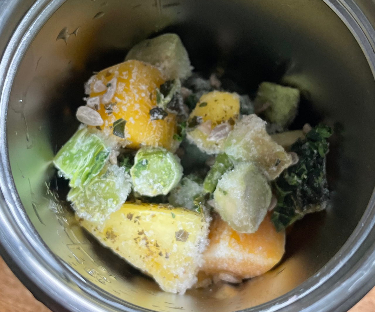 Frozen green smoothie ingredients in the nutribullet Flip&trade; Insulated Portable Blender