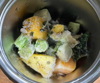 Frozen green smoothie ingredients in the nutribullet Flip™ Insulated Portable Blender