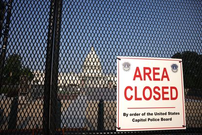 Fenced-in Capitol building.