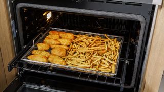 Food cooking on a air fryer rack in a GE Appliances range