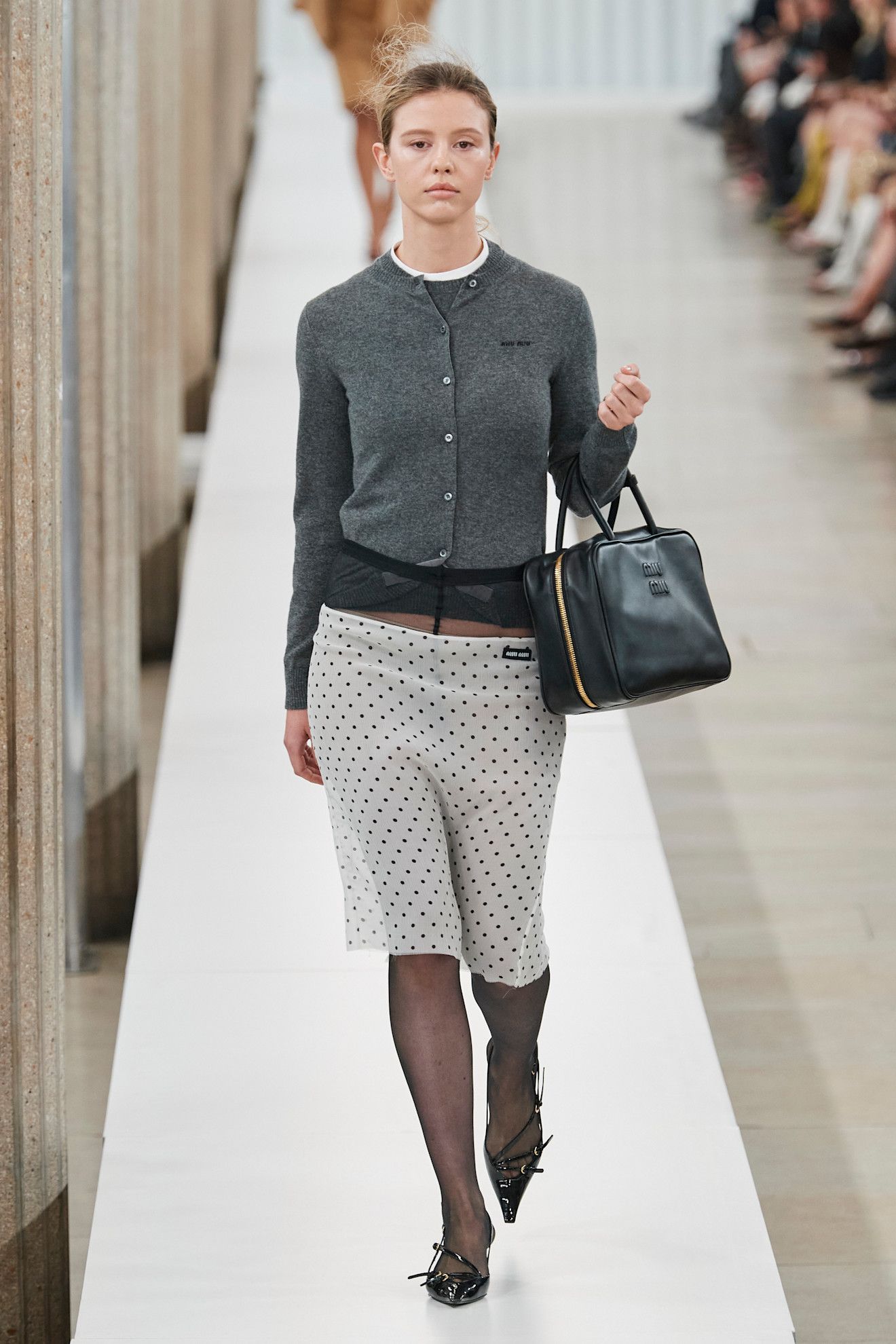 An image of a cardigan on Miu Miu's autumn/winter 2023 runway.