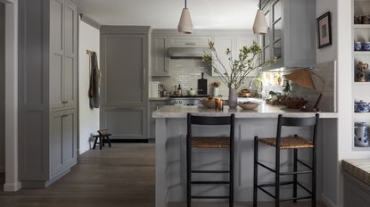 small grey kitchen with counter seating and banquette