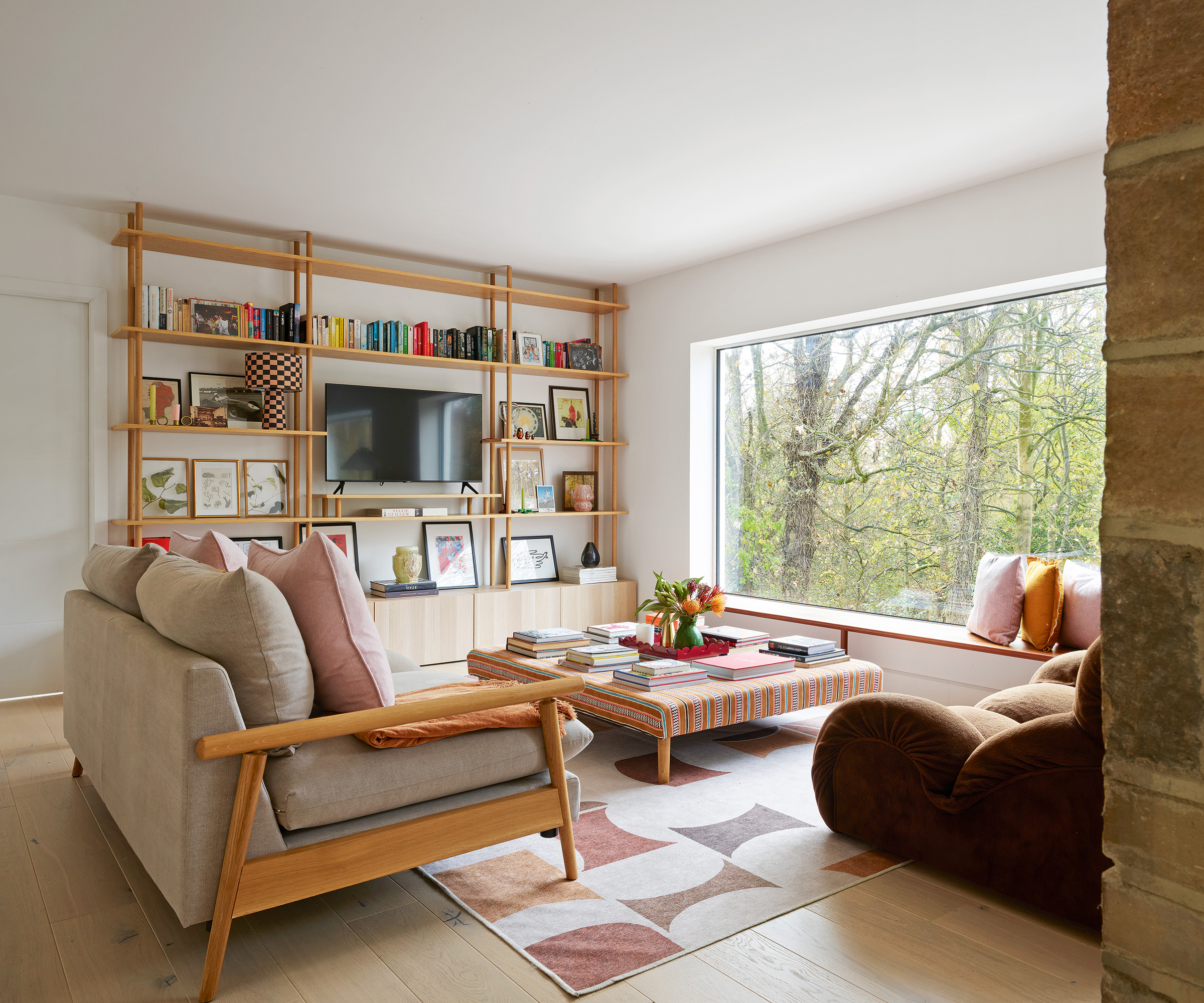 Interior of a 1960s house with mid-century modern style furniture and large picture window