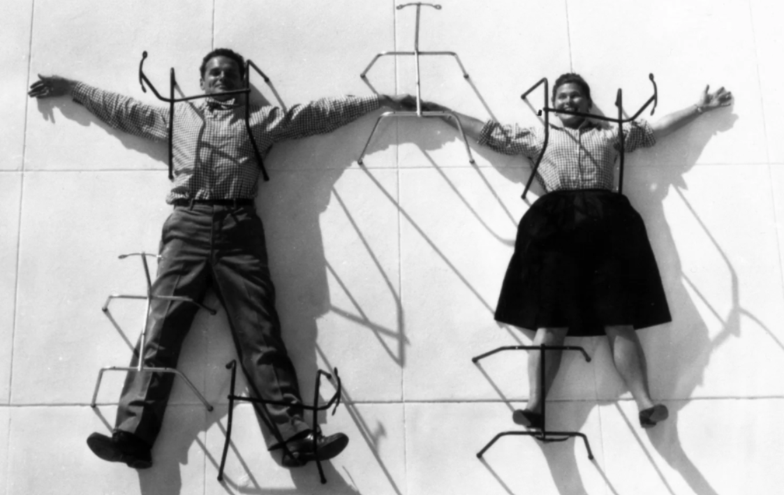 Pictured: Charles and Ray Eames posing with their chair bases