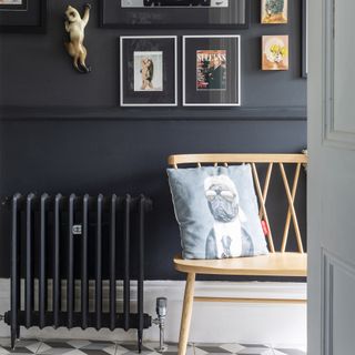 Hallway with rattan chair and painted black radiator.