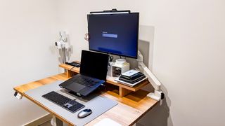 Desky Dual Hardwood standing desk with laptop, monitor and peripherals