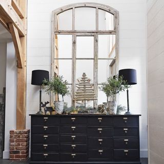 black console table with large mirror on top and simple Christmas decor