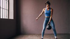 A woman performing a kettlebell swing