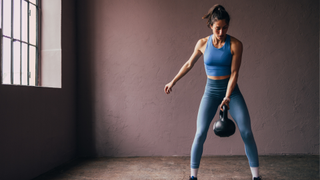 A woman performing a kettlebell swing