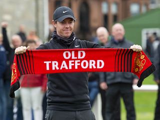 Rory McIlroy holding up a Manchester United 'Old Trafford' scarf
