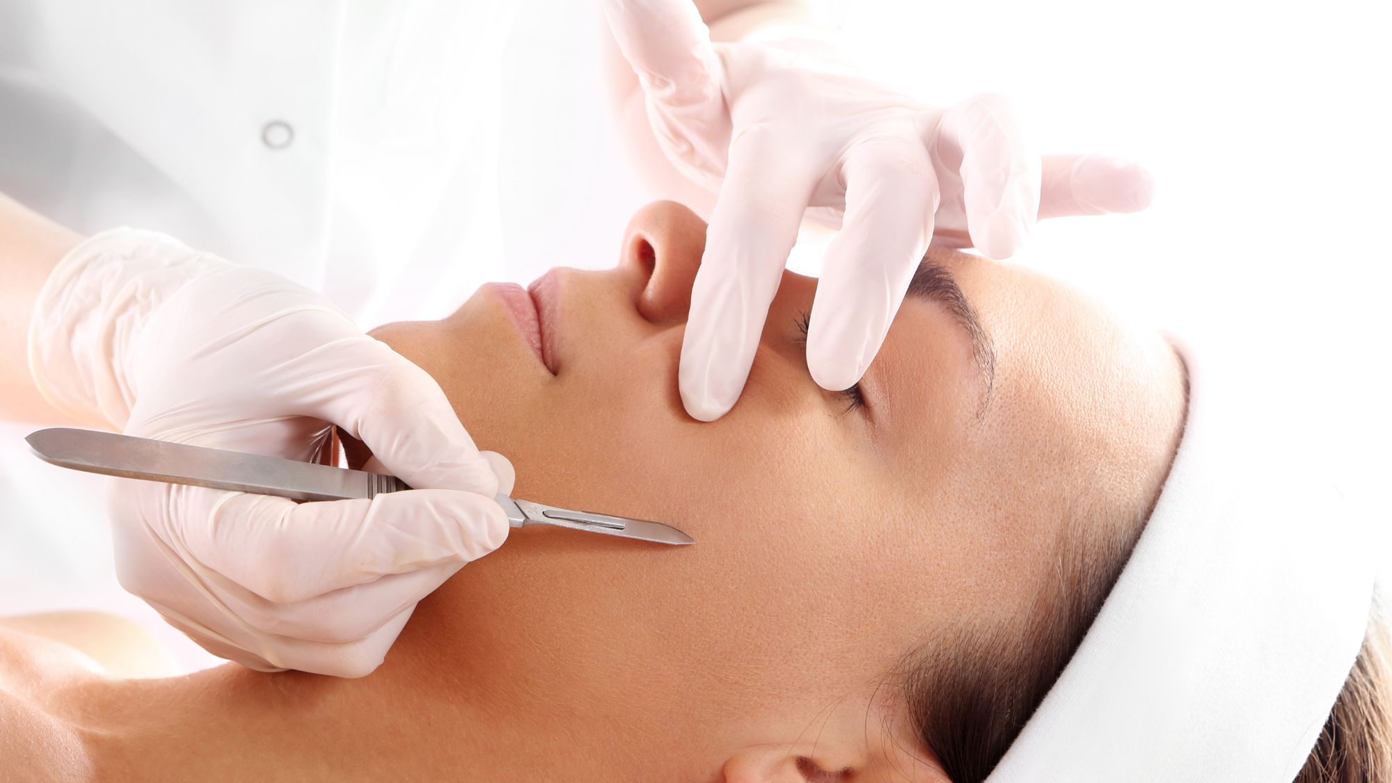 woman getting an in-clinic dermaplaning treatment