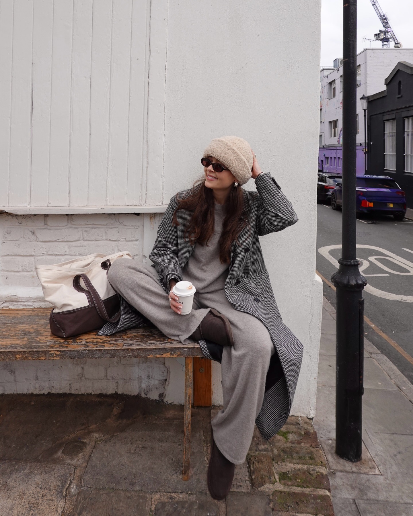 Fashion person the Alice edit shows hwat to wear to the pub. She wears a matching set, grey check coat and shearling hat.