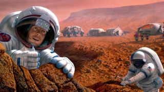 Two astronauts wearing white spacesuits dig around in the dirt near a series of gray buildings on the reddish dusty surface of the planet Mars