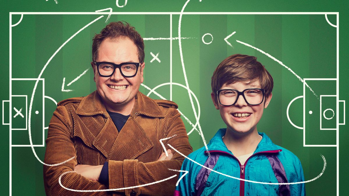 Alan Carr and Young Alan (Oliver Savell) standing in front of a drawing of a football pitch with tactics arrows drawn across them in the key art for ITV&#039;s Changing Ends.