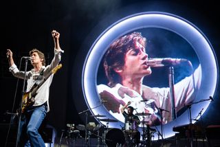Alex Turner of Arctic Monkeys sings on stage at the Merriweather Post Pavilion